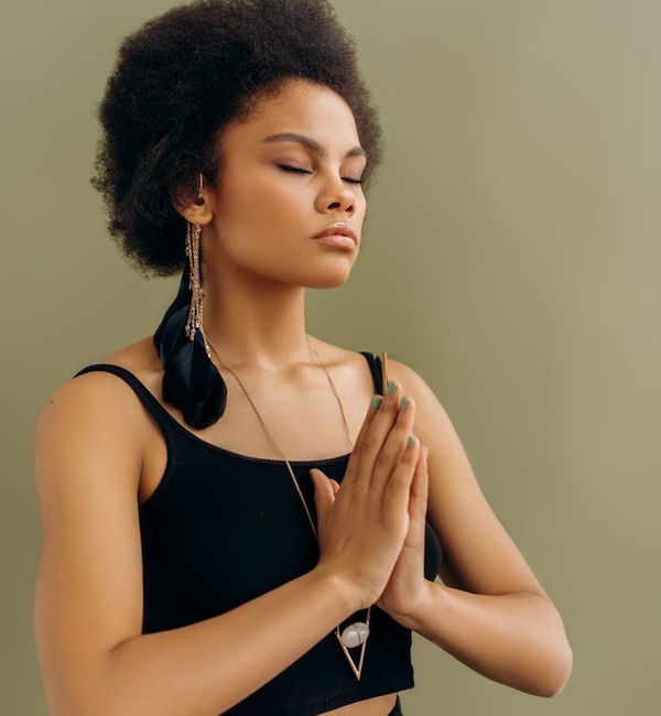 Woman in a peaceful lotus yoga pose with eyes closed.